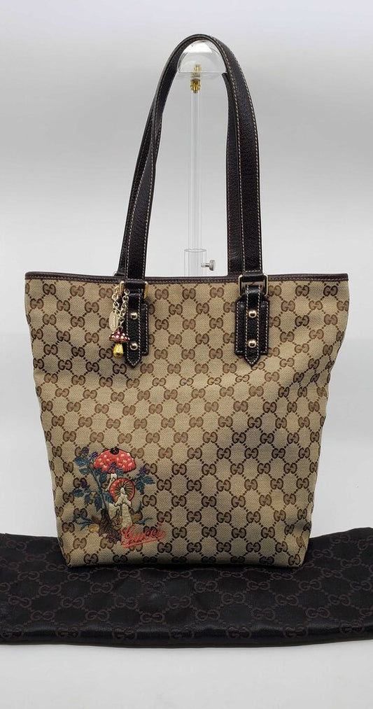 Gucci Beige/Brown GG Canvas tote bag featuring mushroom embroidery and a mushroom charm